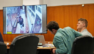 A still image from a video shows Sade Robinson, left, arriving at the Twisted Fisherman restaurant where she met Maxwell Anderson, seated in court on the right, with his defense attorney Anthony Cotton, left, in Milwaukee County Circuit on Monday (Milwaukee Journal-Sentinel)